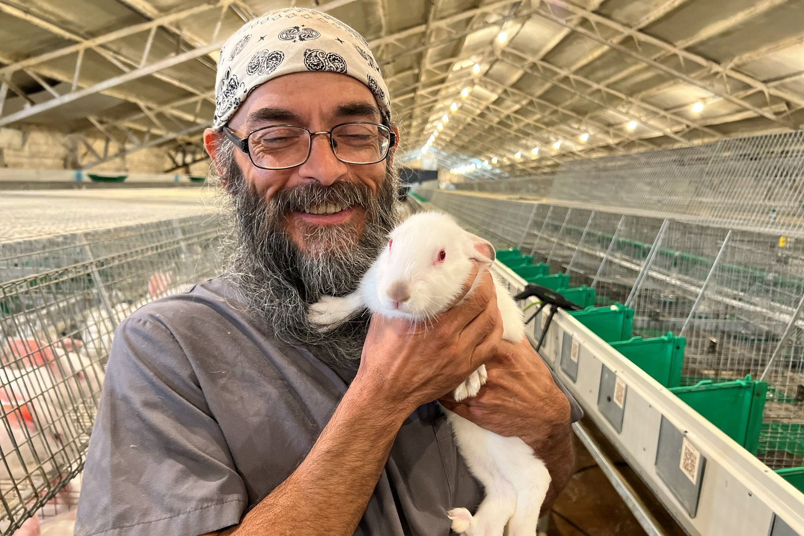 Pel-Freez grower with a New Zealand White rabbit